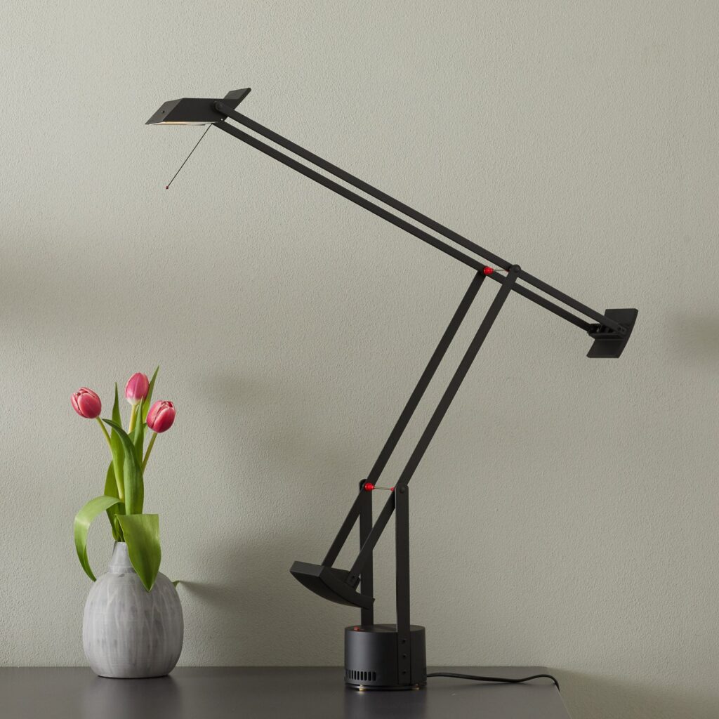 Artemide Tizio in Schwarz auf einem Schreibtisch mit Tulpen
