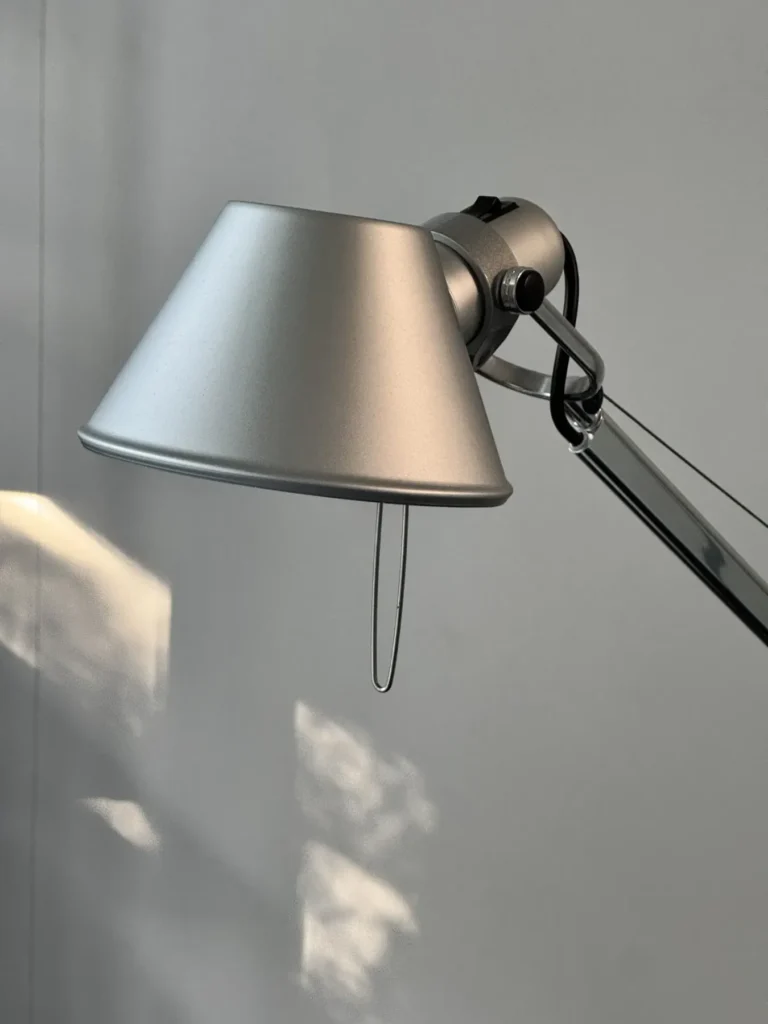 Lampenschirm der Artemide Tolomeo aus Aluminium vor einer grauen Wand